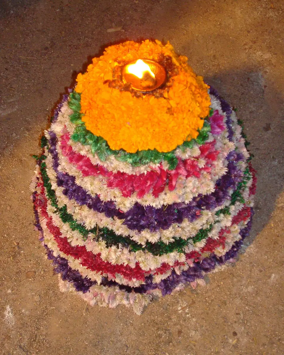 A bathukamma: flowers stacked in rings into a cone.