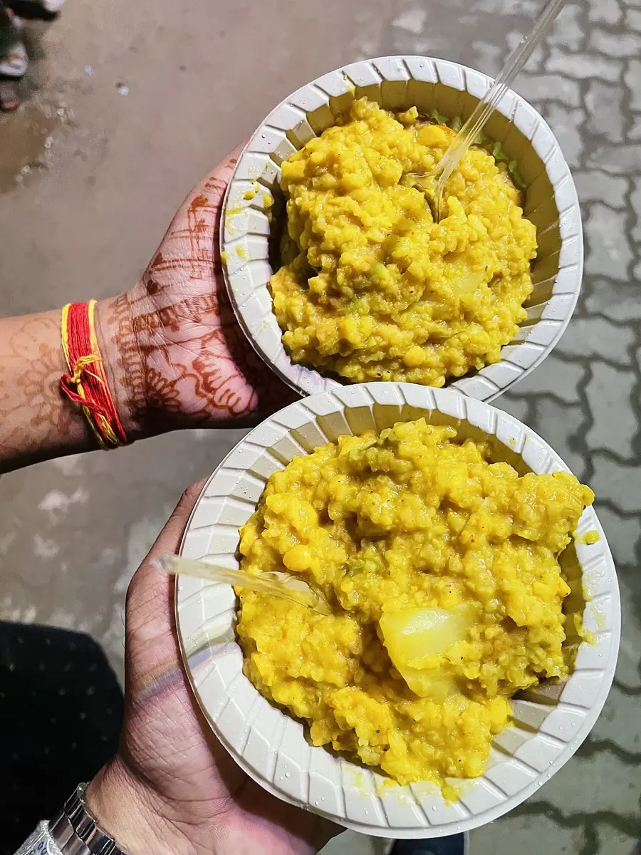 Khichuri bhog served in leaf bowls at a Durga Puja.