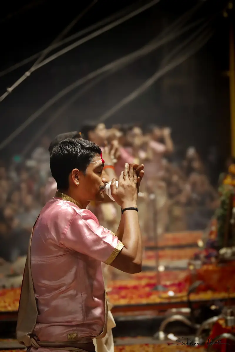 Blowing the shankha, the conch, during worship.
