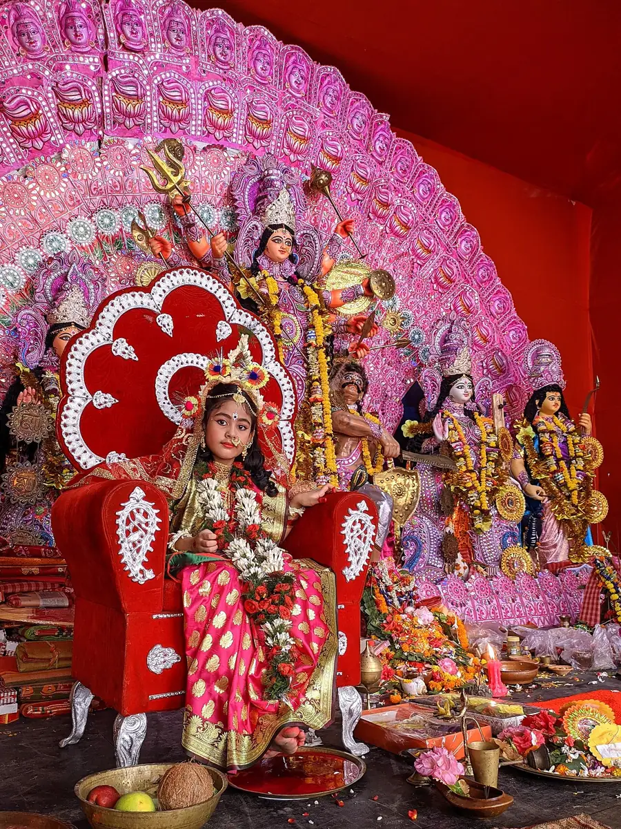 A young girl is worshipped as the goddess in Kumari Puja.