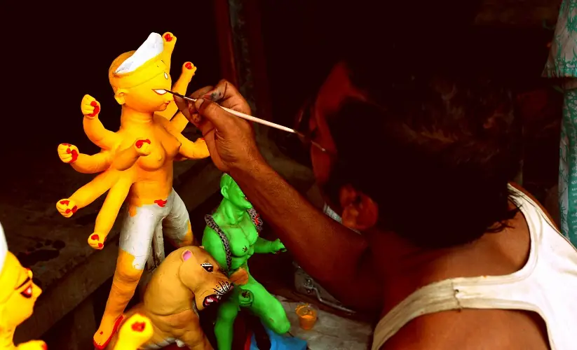 An artisan paints a Durga idol at Kumartuli.