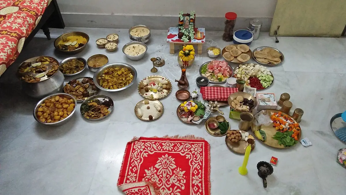 Offerings laid out for Kojagari Lakshmi Puja in a Bengali home.
