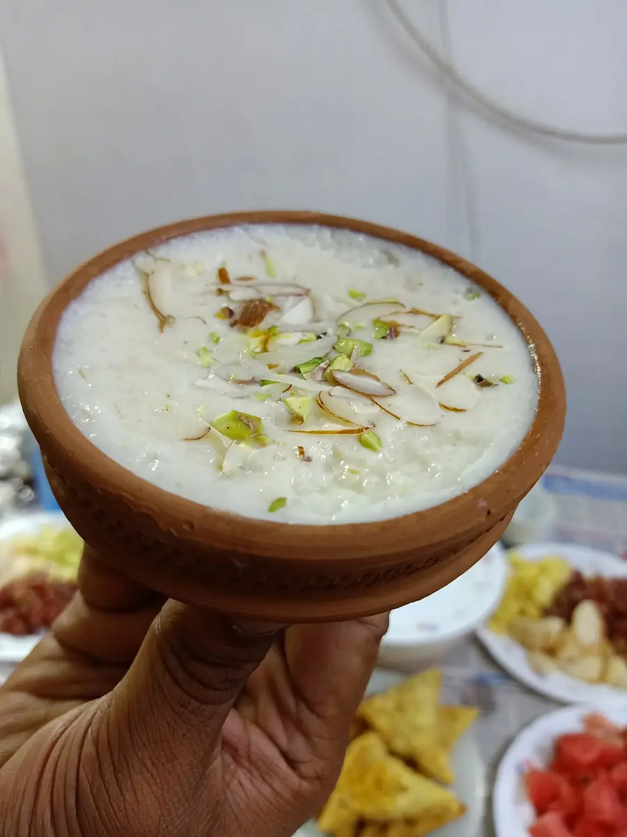 Payesh, rice slow-cooked in milk, in a clay bowl.
