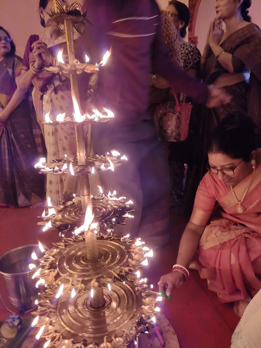 Tiers of lamps are lit for Sandhi Puja at a Kolkata community puja.